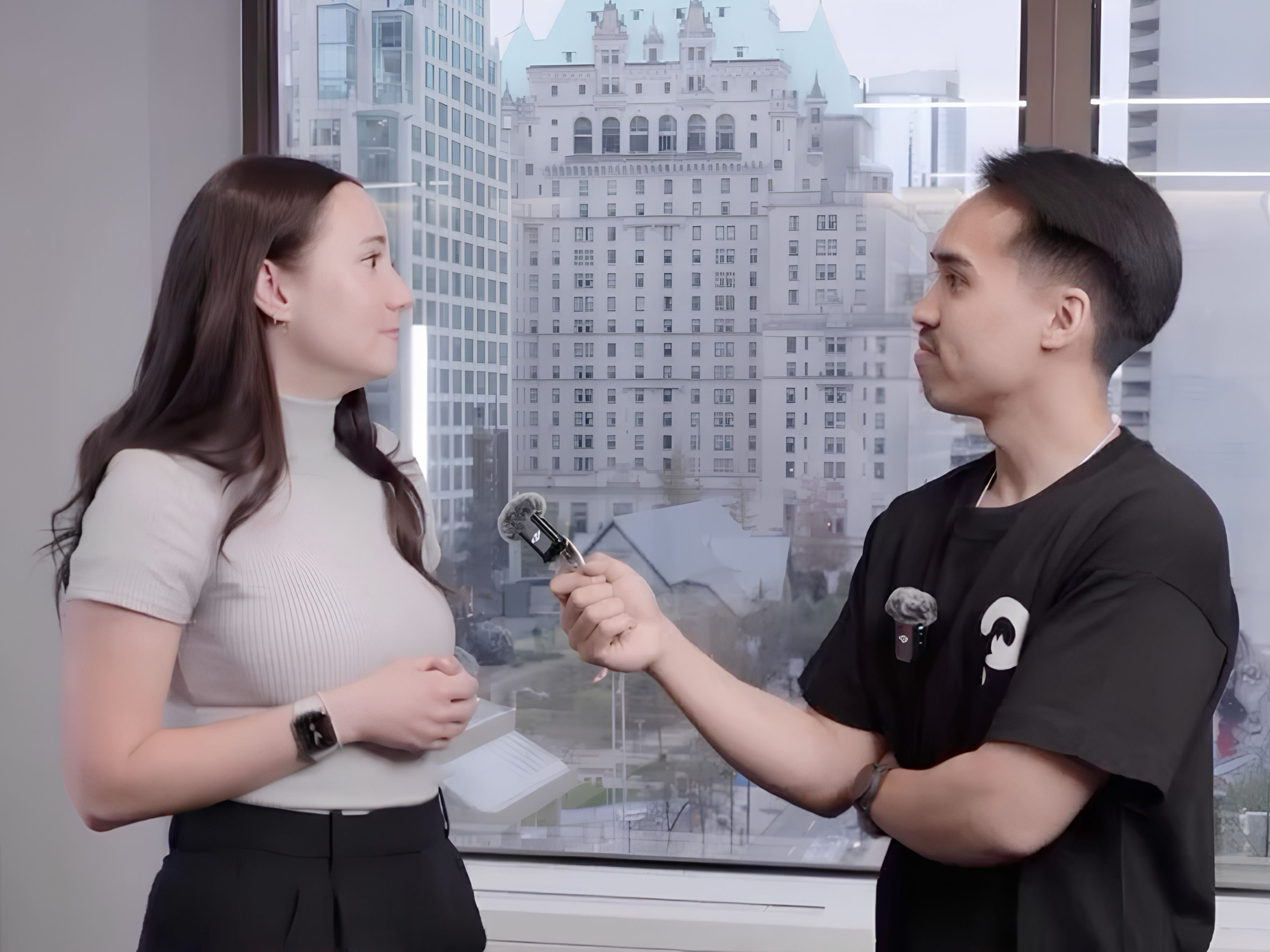 Ania Wysocka being interviewed by Filmosity in front of a window overlooking downtown Vancouver